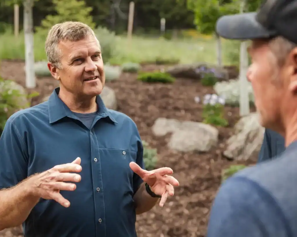 Smooth Stone owner talking with a client on a Montana property
